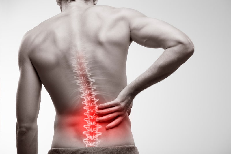 Person holding their lower back in pain